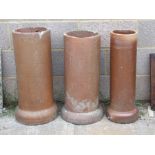 Three terracotta chimney pots / planters, the largest 69cms (27ins) high (3).