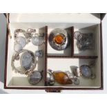A faux crocodile jewellery box containing silver brooches, lockets, pendants, earrings and other