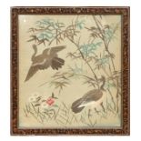 A Chinese silk embroidered panel depicting two geese amongst bamboo, 49 by 54cms (19.75 by 21.