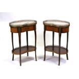 A pair of French kidney shaped bedside tables, the marbled top with gilt metal gallery above a