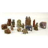 A group of Chinese and Asian soapstone carvings to include figural groups and seals.