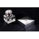 A silver cigarette box, Birmingham 1928; together with a glass inkwell with sterling silver lid (