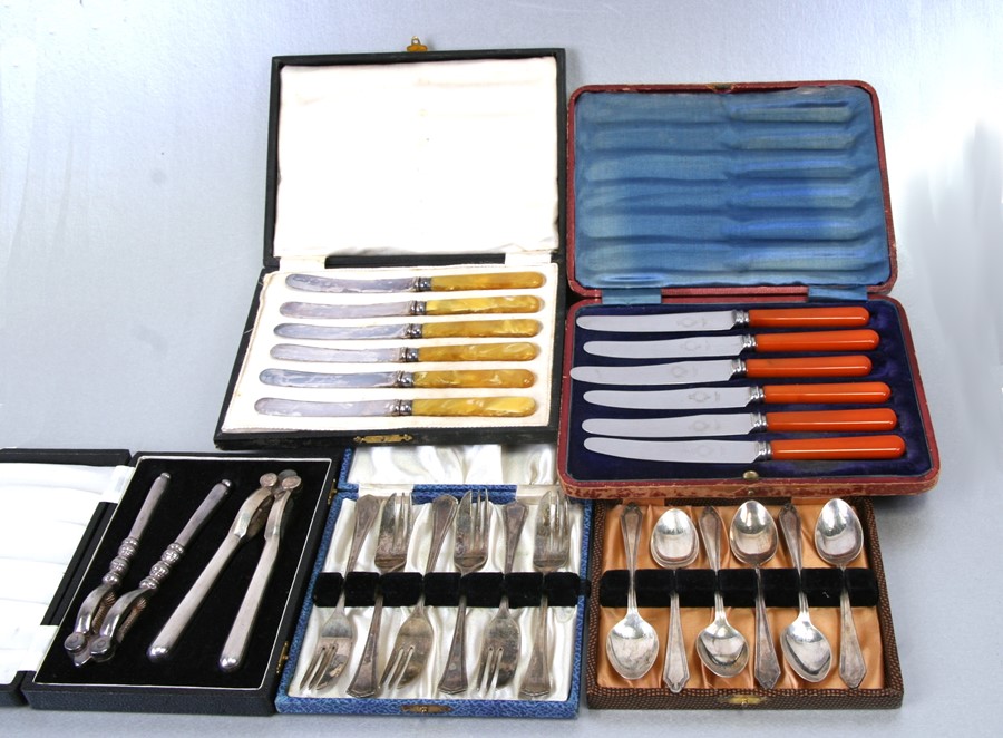 A quantity of silver plated cutlery and cased cutlery; together with a pair of cased nut crackers