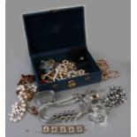 A quantity of costume jewellery in a blue jewellery box.