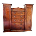 A Victorian mahogany sentry box compactum wardrobe, the central pediment above a bank of drawers