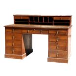 An early 20th century mahogany pedestal desk, the superstructure with pigeon holes and short drawers