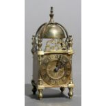 A 17th century style miniature brass lantern clock, 6.5cms (2.5ins) wide.
