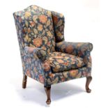 A wingback armchair on cabriole front supports. (a/f)Condition Reportback leg is broken