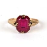 A 9ct gold dress ring set with a large red stone, weight 1.9g, approx UK size 'N'.