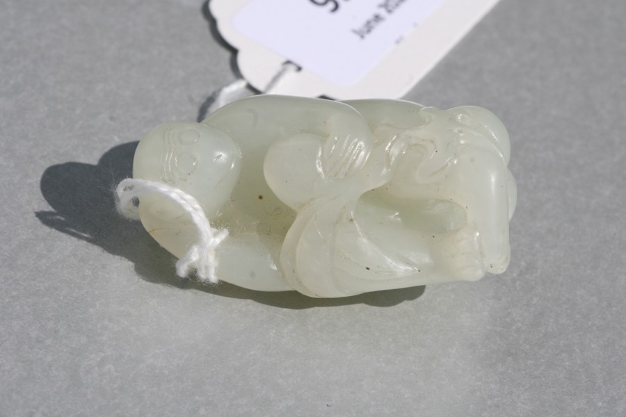 A Chinese jade figure in the form of a monkey holding a fruit, on an associated hardwood stand, 5cms - Image 9 of 9