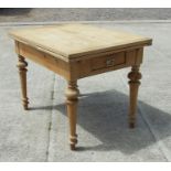 A continental stripped pine draw-leaf kitchen table with two drawers, on turned legs, 77 by