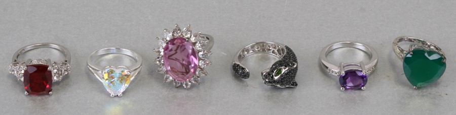 Six ornate silver gem set rings including a panther head.