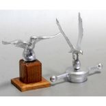 An accessory car mascot in the form of an eagle standing on an orb, mounted on a t-bar radiator cap,