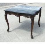 An 18th century style mahogany concertina action fold-over card table with carved frieze on cabriole
