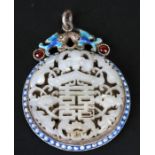 A Chinese pierced jade / hardstone pendant in a white metal and enamel mount, 7cms (2.75ins).