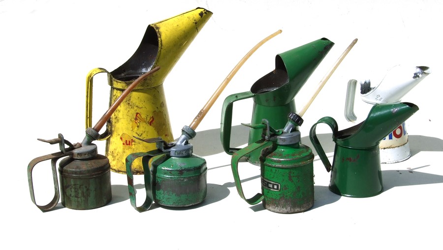 A Shell oil can, a Mobil oil can and five similar oil cans (7).