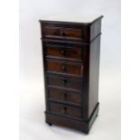 A French walnut cabinet with marble top above a pot cupboard and an arrangement of drawers, on a