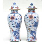 A pair of Chinese Imari pattern baluster vases and covers, 23cms (9ins) high.Condition