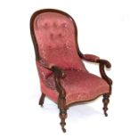 A Victorian mahogany button backed armchair with upholstered seat and back, on turned front