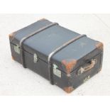 A black leather cloth travelling trunk,with leather reinforced corners and twin carrying handles,