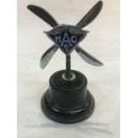An Accessory car mascot, in the form of twin propellers, chrome plated with an enamel central