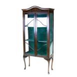 An Edwardian two-door display cabinet on cabriole legs, 72cms (28.25ins) wide.