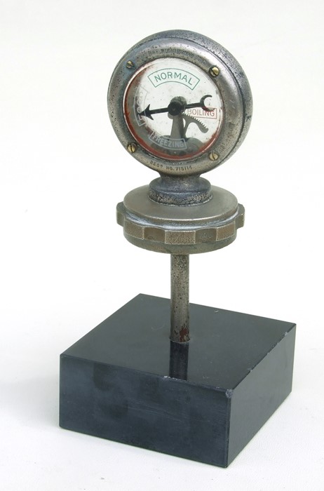 A Wilmot Calometer on a radiator cap mounted on a plinth.