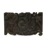 A carved wooden panel depicting a Hippocampus, snake and a bird, 40cms (16ins) wide.