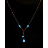 A 9ct gold necklace with turquoise coloured glass bead drops.