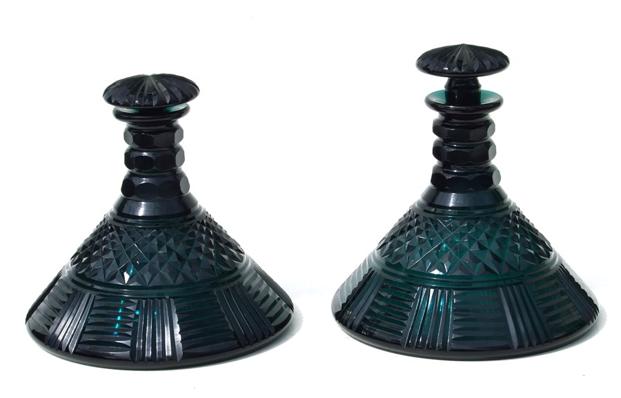 A pair of 19th century facet cut green glass ships decanters and stoppers, 20cms (8ins) diameter (