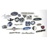 A large quantity of bonnet badges for various marques including Ford, BMW, Volkswagen, Range