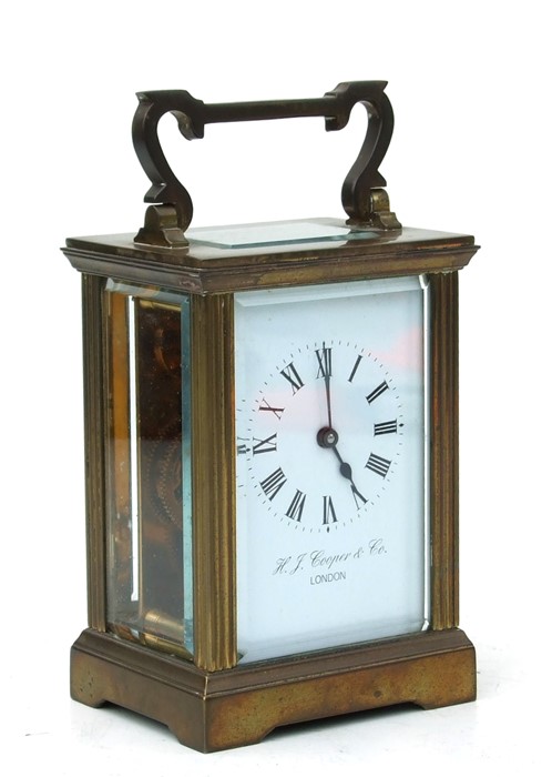 A four-pillar gilt brass carriage clock, the rectangular enamel with Roman numerals and signed 'H