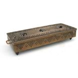 An Indian brass three burner table top heater, 46cms (18ins) wide.