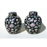A pair of large Chinese famille noir ginger jars and covers. 28cm (11 ins) high