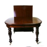 A Victorian mahogany extending dining table with two extra leaves, raised on faceted baluster