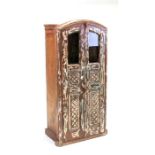 A distressed painted two-door teak cupboard, 64cms (25ins) wide.