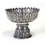 A Thai white metal bowl on stand decorated with flowers, 11cms (4.25ins) high.