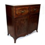 A Regency mahogany secretaire cupboard, the secretaire drawer with fitted interior above a pair of