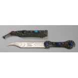 A Middle Eastern white metal filigree and hardstone mounted dagger and scabbard, 23cms (9ins) long.