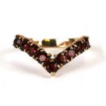 A 9ct gold wishbone ring set with red stones, possibly garnets, weight 2.6g, approx UK size 'L'