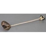An unusual spoon with limpet shell bowl, vertebrae shaft and skull terminal, 25cms (9.75ins) long.