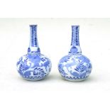 A pair of Chinese blue & white bottle vases decorated with deer and flowers, 15cms (6ins) high (2).