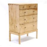 A stripped pine chest on stand with three small drawers above three long drawers, mounted on a