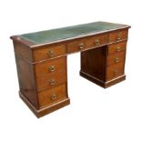 A late 19th century walnut pedestal desk with an arrangement of nine drawers, on a plinth base,