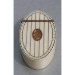 A Georgian ivory oval snuff box with yellow metal decoration and yellow metal oval blank cartouche