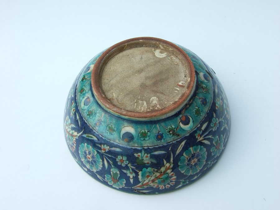 An Iznik pottery bowl decorated with flowers on a green ground, 27cms (10.5ins) diameter; together - Image 5 of 17