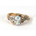 A 9ct gold aquamarine and white stone ring, approx UK size 'N'.