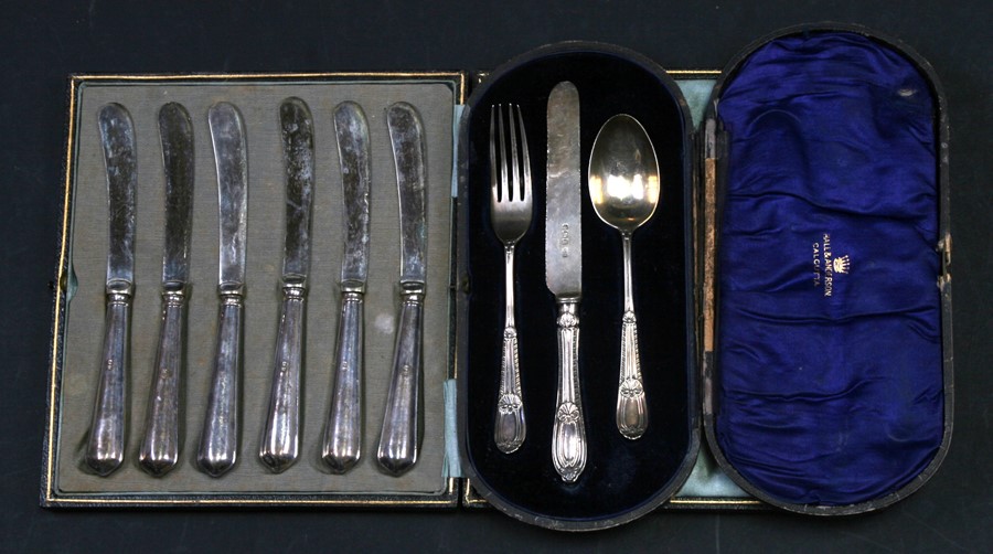 A boxed silver christening set; together with a boxed set of silver handled butter knives, and a