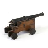 A desktop cannon with brass / bronze barrel with engraved decoration, on a wooden carriage, 16cms (