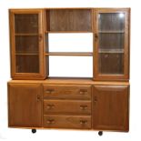 An Ercol Windsor display wall unit, the upper section with two open bookshelves flanked by two